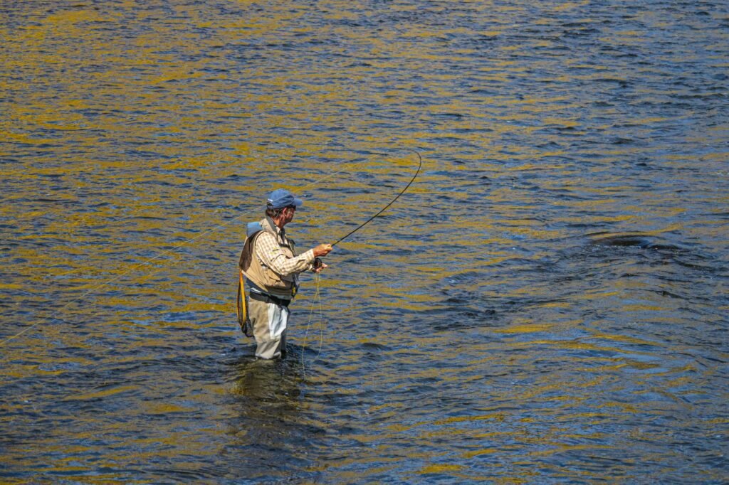all what you need to be an angler. fisherman with his rod in the river