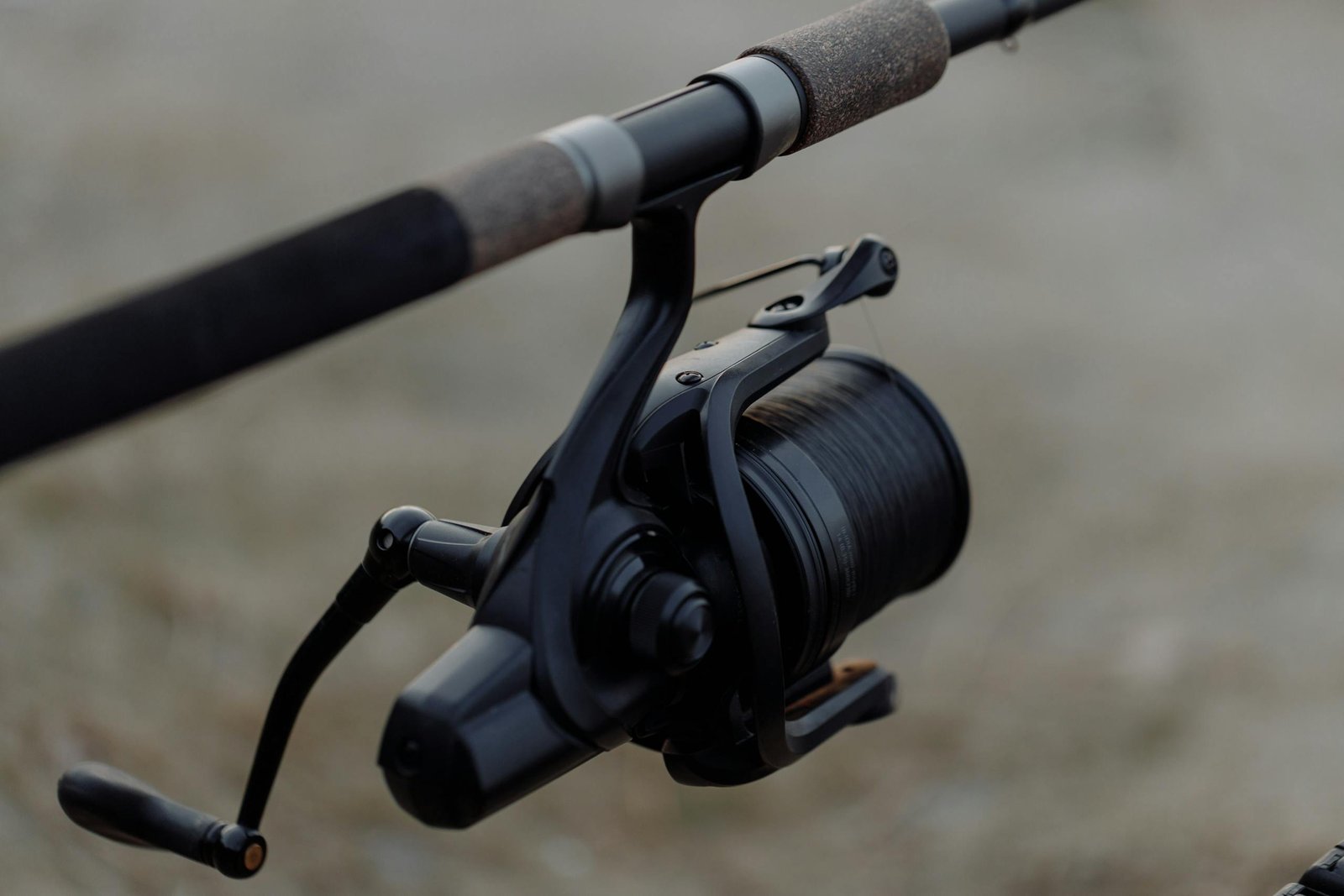 fishing reel on a rod, perfect for outdoor enthusiasts.